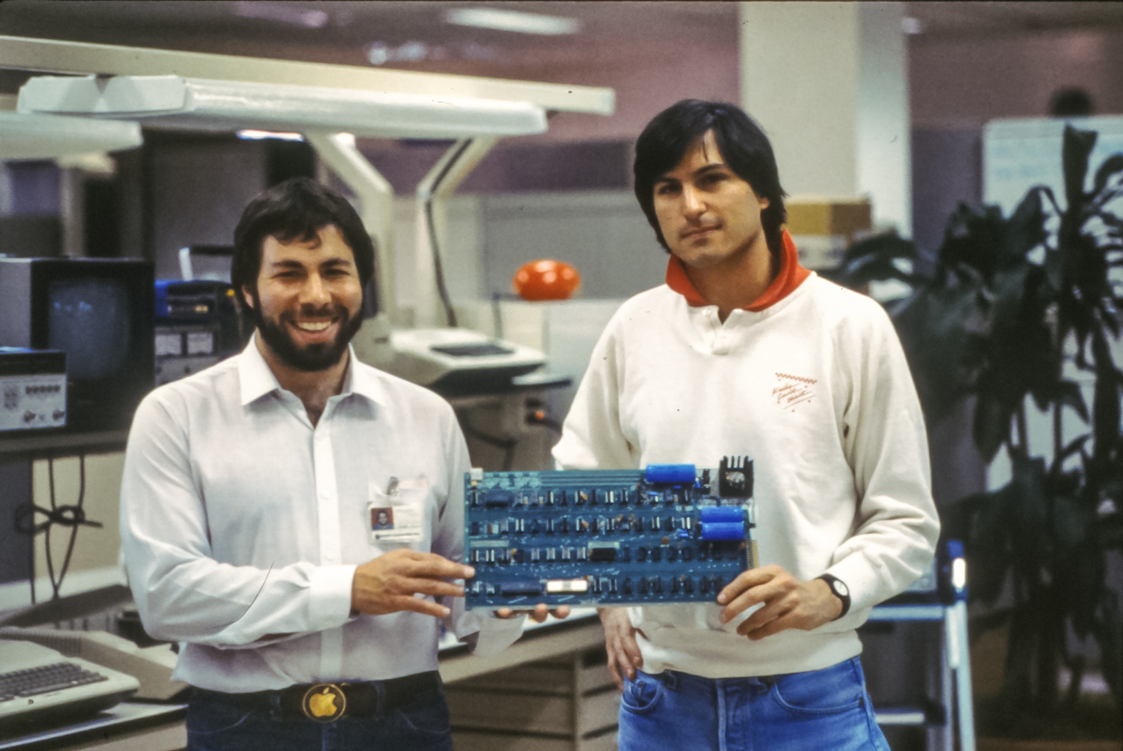 Steve Wozniak and Steve Jobs holding an Apple-1 computer board