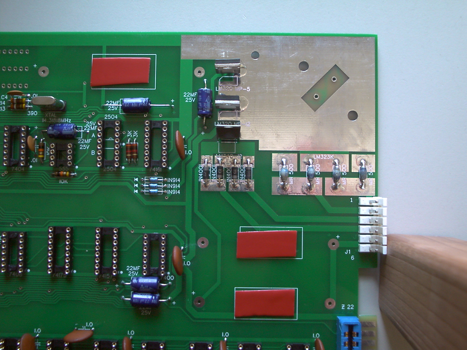 Small patches of sticky tape on Apple-1 PCB