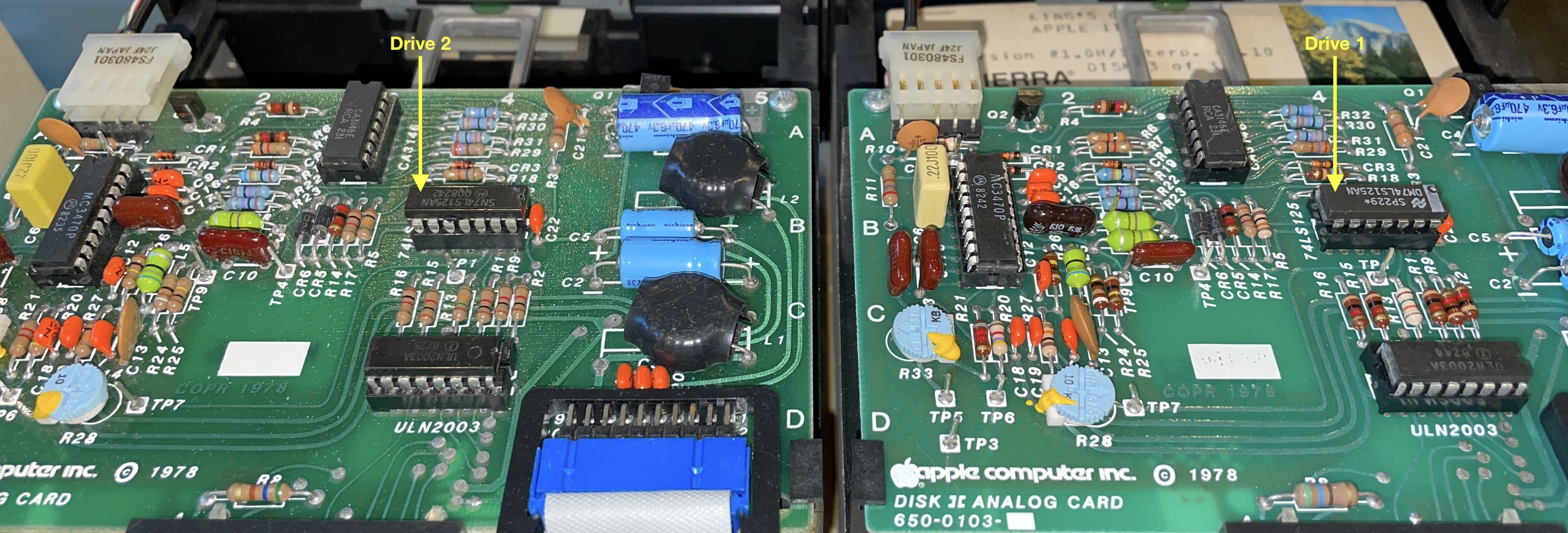 Two Apple Disk II analog boards with arrows pointing at 74LS125 chips