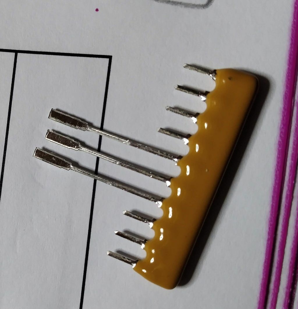 Image of resistor pack with long legs. The legs are for automation of assembly.