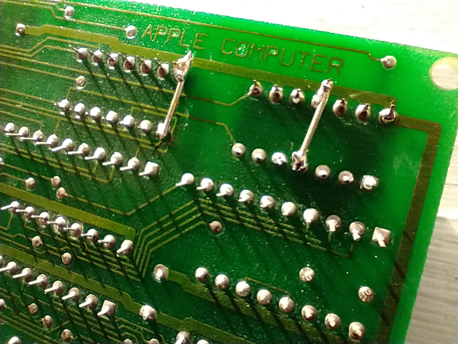 Back of a circuit board with two extra wires soldered on